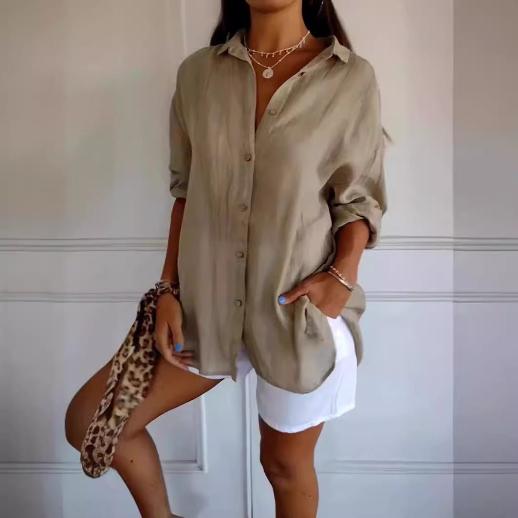 Woman in olive button-down shirt with rolled sleeves, white shorts, and leopard print scarf