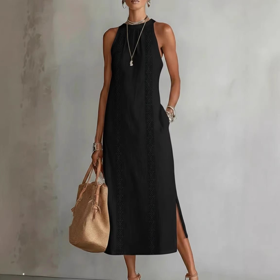 Black sleeveless midi dress with lace trim, side slit, and pocket, styled with straw tote and sandals
