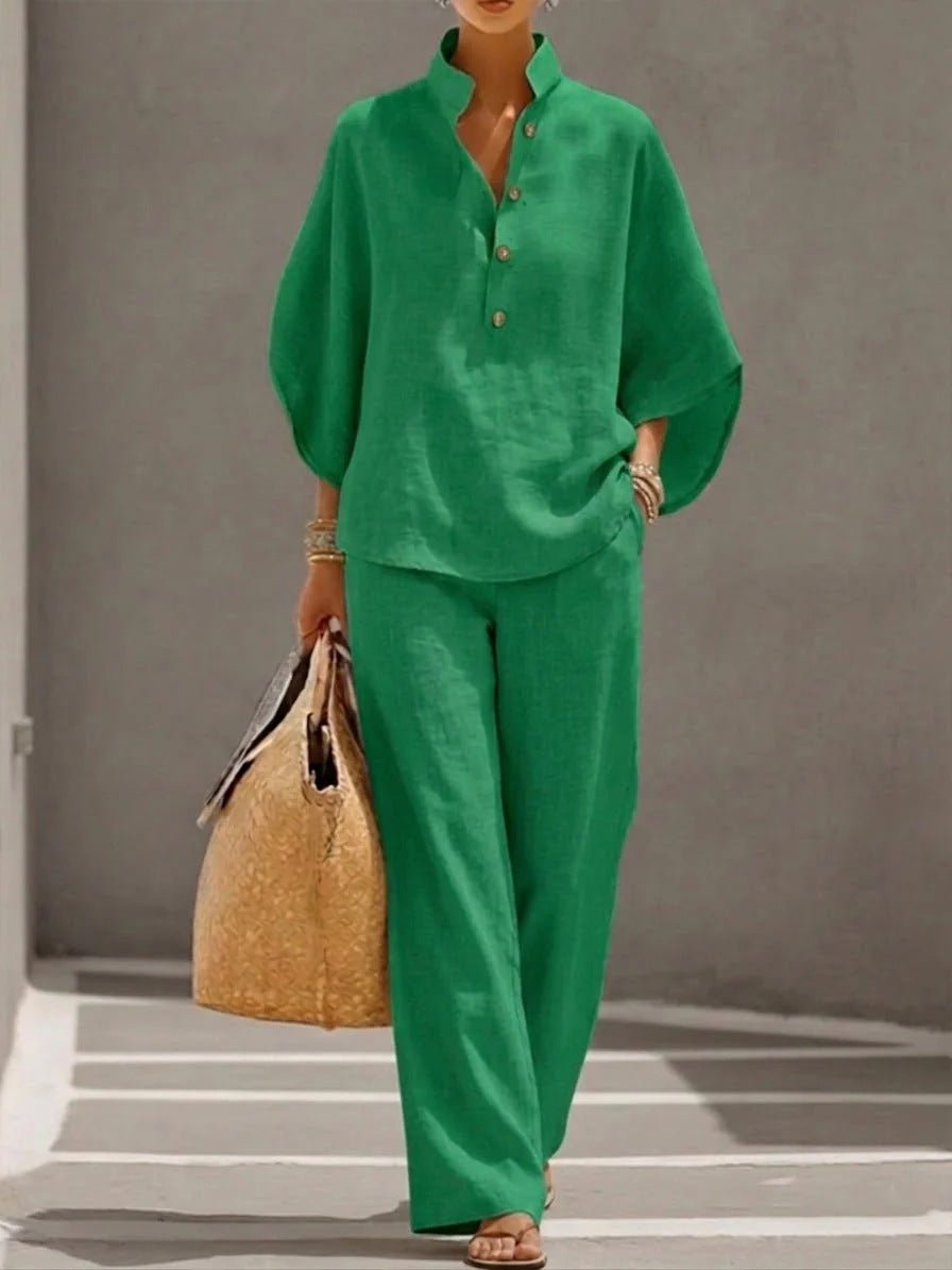 Woman in green linen shirt and wide-leg pants, carrying woven tote bag, stylish casual outfit