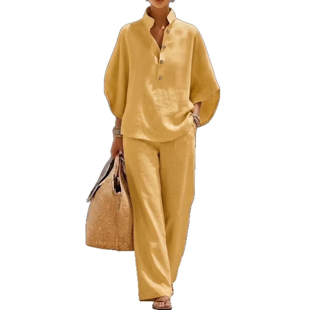 Yellow linen pantsuit with button-up top, wide-leg trousers, and straw bag for casual summer wear